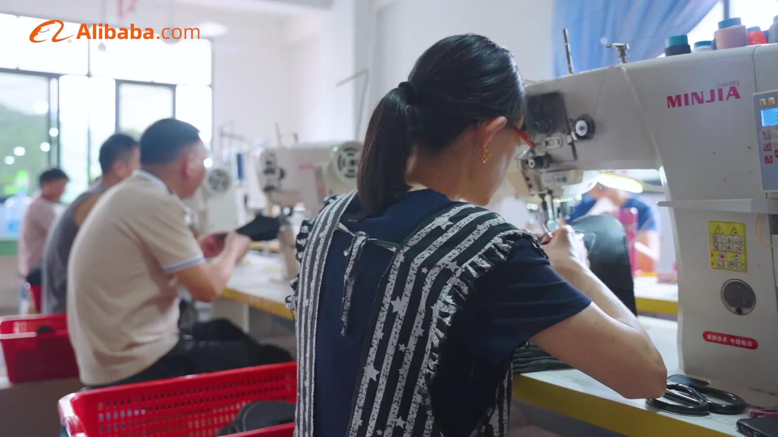 Stitching work area visible in the supplied factory footage